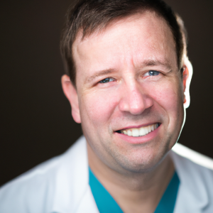 a professional and visually appealing image of a young happy smiling caucasian doctor with white teeth