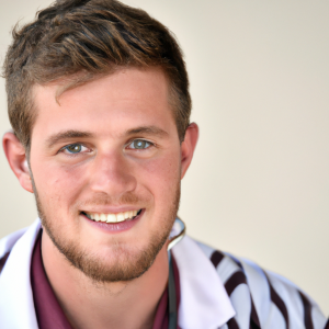 a professional and visually appealing image of a young happy smiling caucasian doctor with white teeth