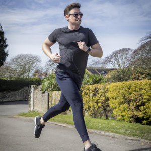 a professional appealing image of a caucasian man or woman jogging on a sunny day