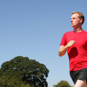 a professional appealing image of a caucasian man or woman jogging on a sunny day