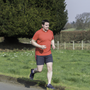 a professional appealing image of a caucasian man or woman jogging on a sunny day