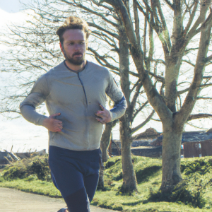 a professional appealing image of a caucasian man or woman jogging on a sunny day