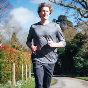 a professional appealing image of a caucasian man or woman jogging on a sunny day