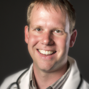 a professional and visually appealing image of a young happy smiling caucasian doctor with white teeth