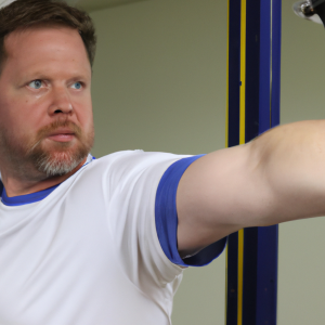 a professional appealing good looking and atheletic image of a caucasian man exercising in a gym