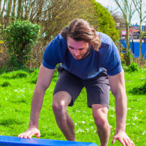 a professional appealing good looking and atheletic image of a caucasian man exercising or playing sports outside on a sunny day