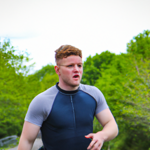 a professional appealing good looking and atheletic image of a caucasian man exercising or playing sports outside on a sunny day